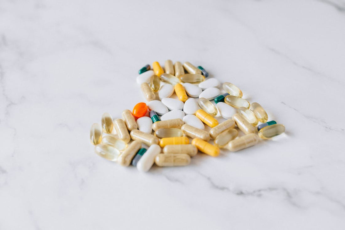 Natural supplements and capsules on a marble surface