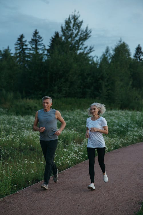 Active senior couple jogging outdoors